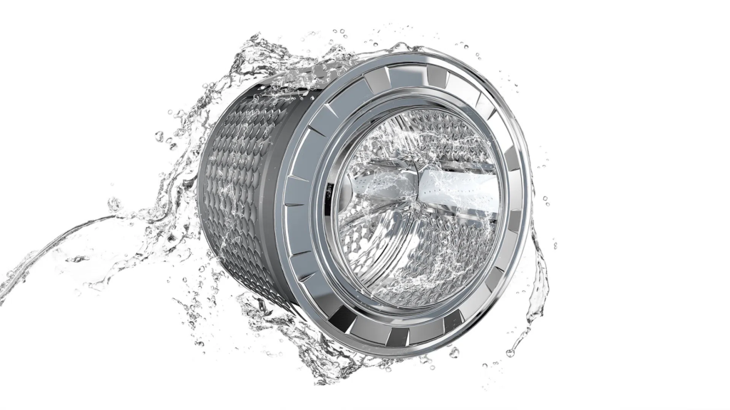 Close-up of a shiny washing machine drum with water splashing around it